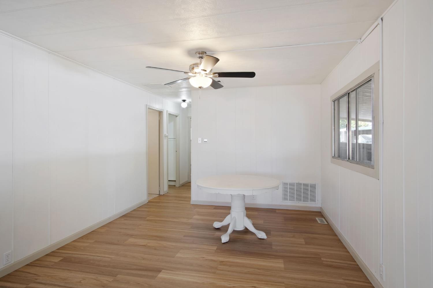 2621 Prescott Road, Unit 224 224 Modesto, CA 95350 - Photo 14 of 23 a view of a room with wooden floor and a ceiling fan