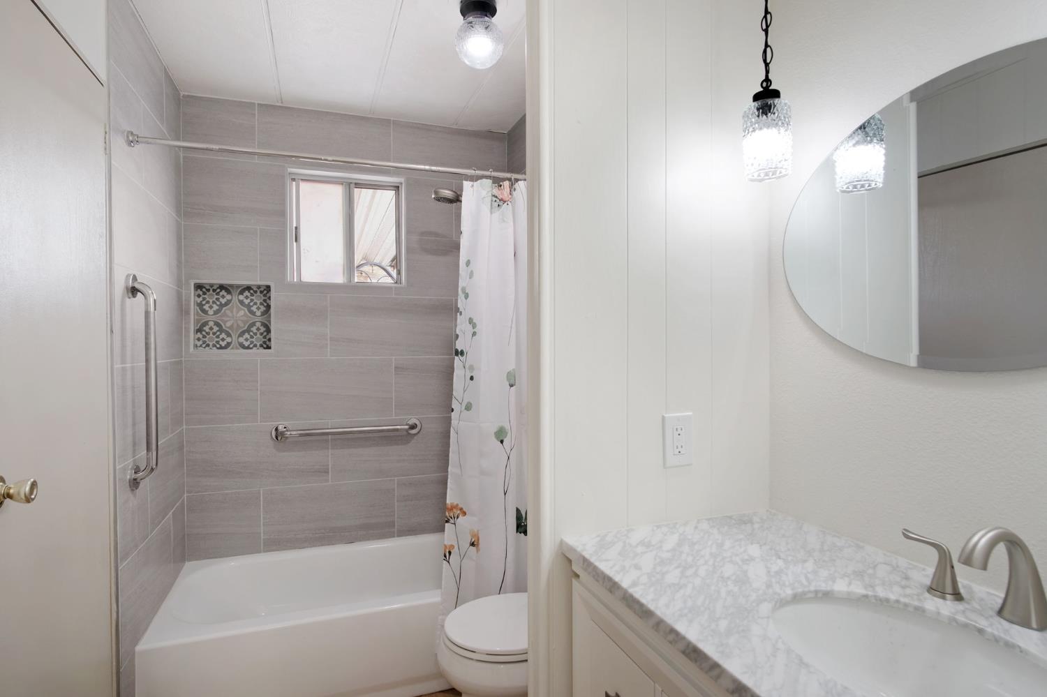 2621 Prescott Road, Unit 224 224 Modesto, CA 95350 - Photo 18 of 23 a bathroom with a granite countertop sink a toilet and shower