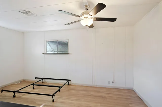 a view of room with window and ceiling fan