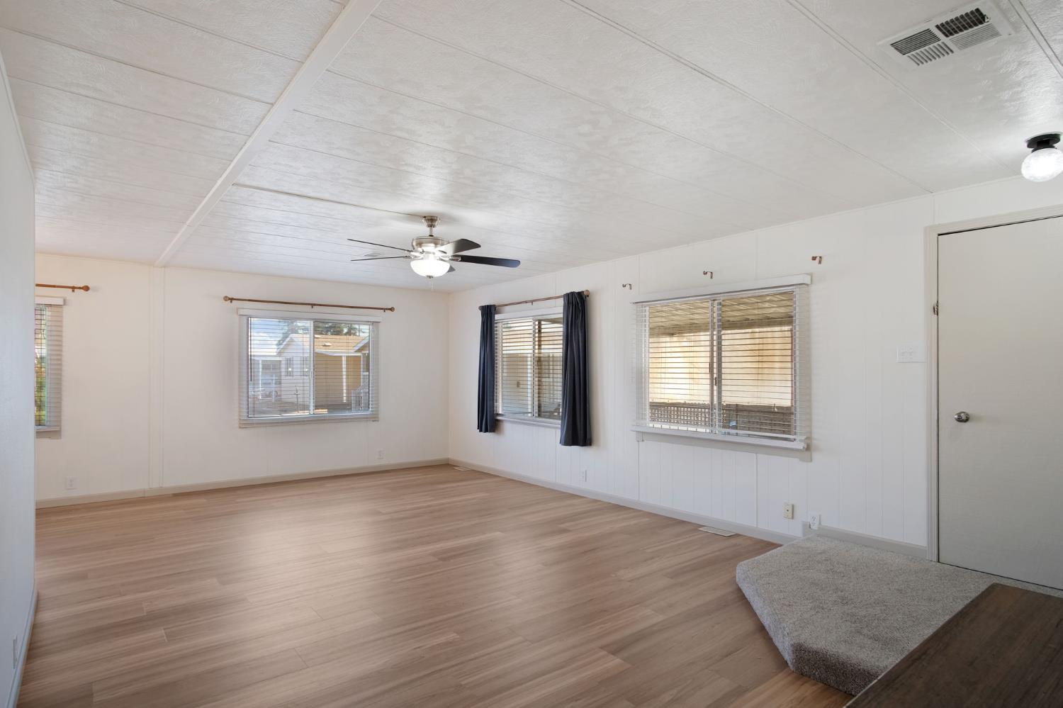2621 Prescott Road, Unit 224 224 Modesto, CA 95350 - Photo 5 of 23 a view of an empty room with wooden floor and a window