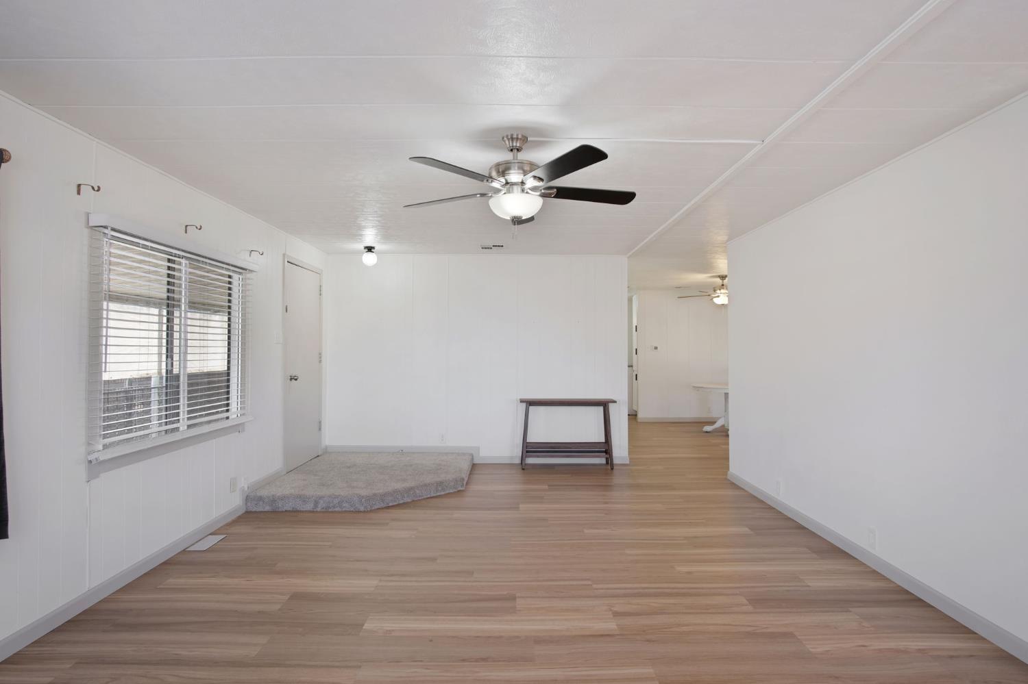 2621 Prescott Road, Unit 224 224 Modesto, CA 95350 - Photo 7 of 23 a view of an empty room with a window and a kitchen
