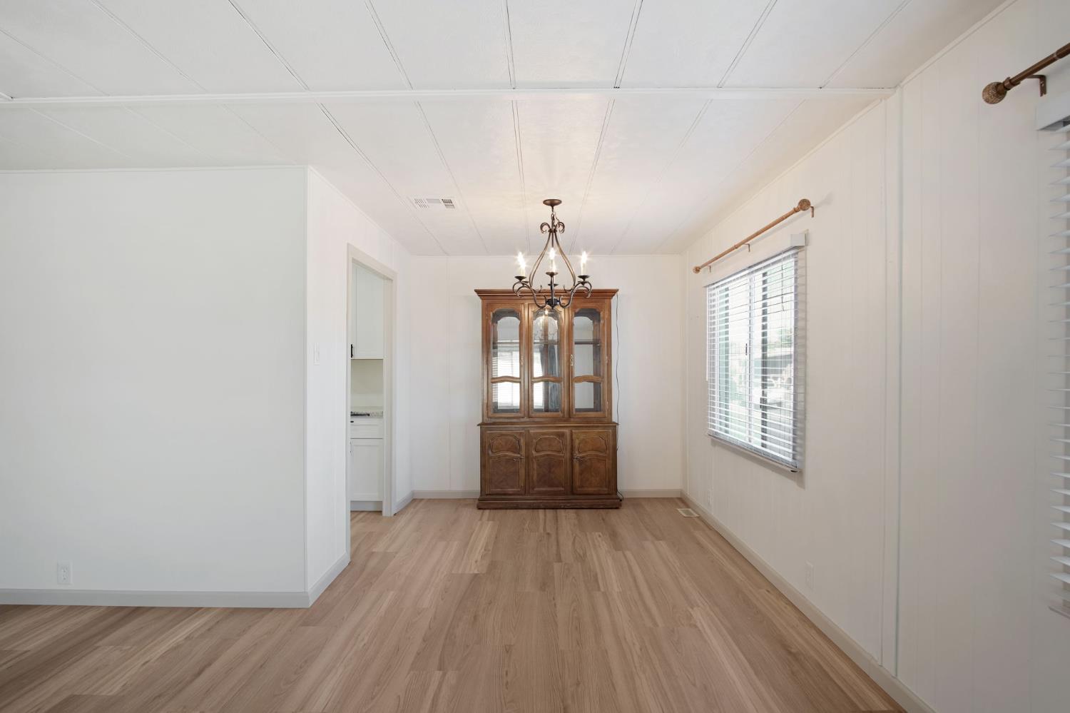 2621 Prescott Road, Unit 224 224 Modesto, CA 95350 - Photo 9 of 23 a view of an empty room with wooden floor and a window