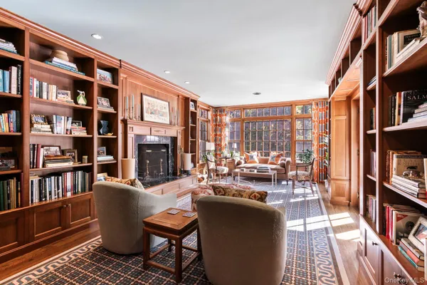 a living room with fireplace furniture and a book shelf