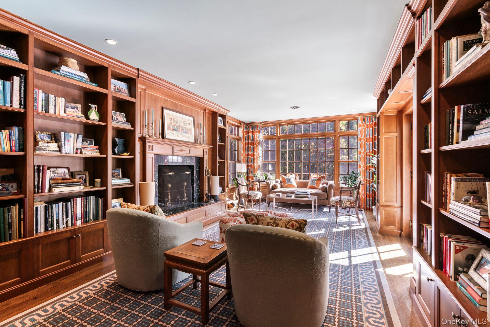 30 Underhill Road Locust Valley, NY 11560 - Photo 12 of 32 a living room with fireplace furniture and a book shelf