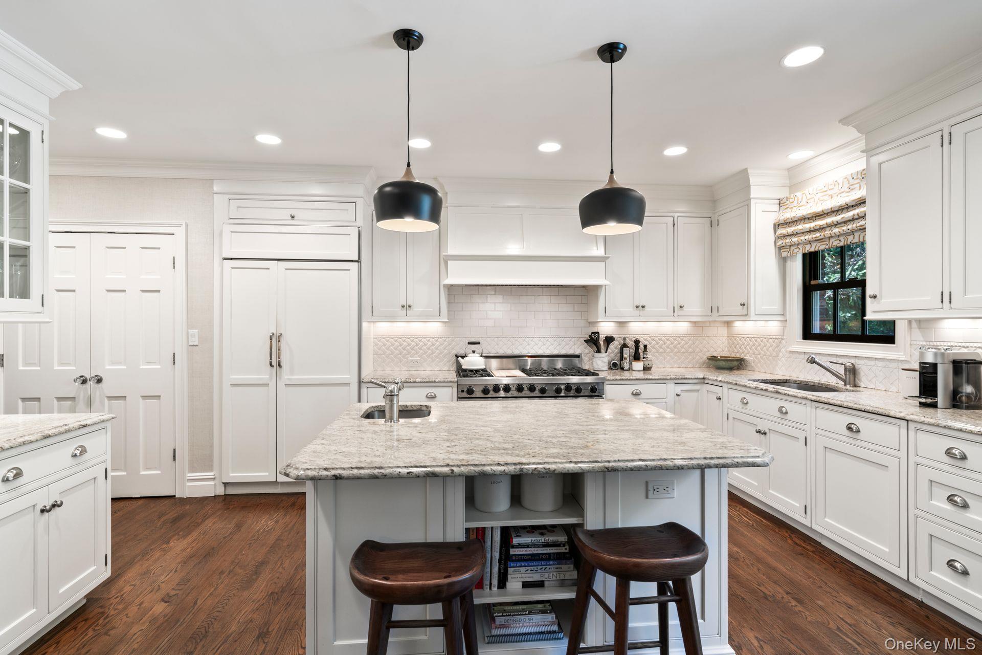 30 Underhill Road Locust Valley, NY 11560 - Photo 18 of 32 a kitchen with stainless steel appliances granite countertop a sink a stove a refrigerator and chairs