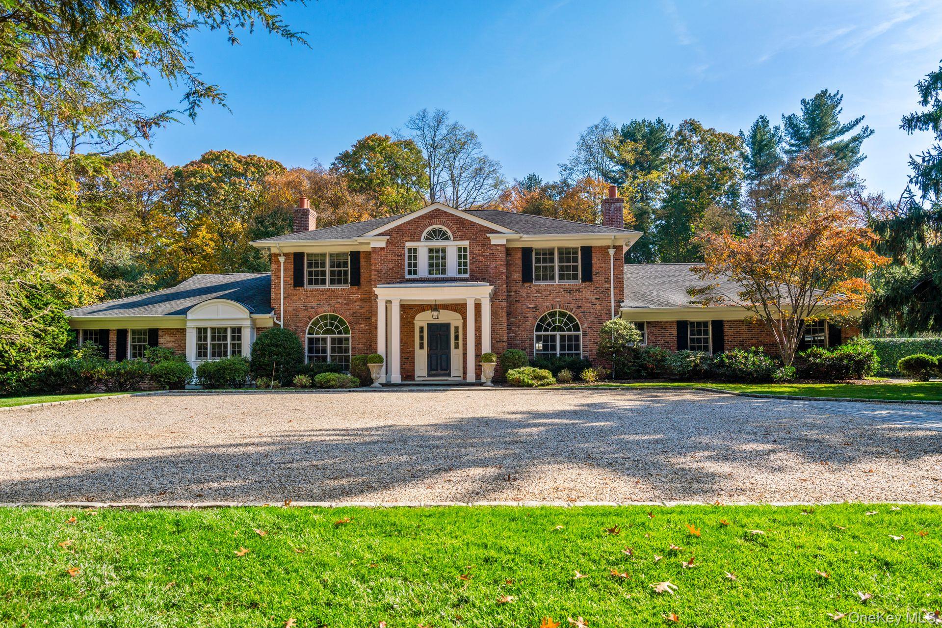 30 Underhill Road Locust Valley, NY 11560 - Photo 2 of 32 a front view of a house with a garden