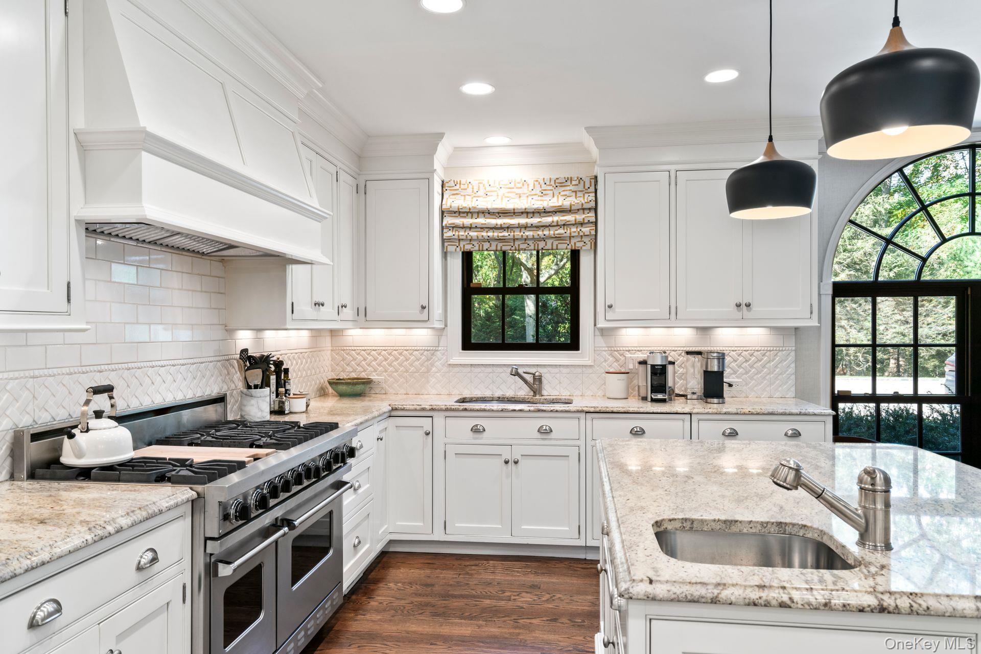 30 Underhill Road Locust Valley, NY 11560 - Photo 21 of 32 a kitchen with stainless steel appliances granite countertop a sink a stove and a wooden floors