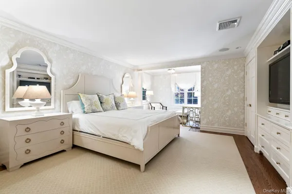 a spacious bedroom with a bed and window
