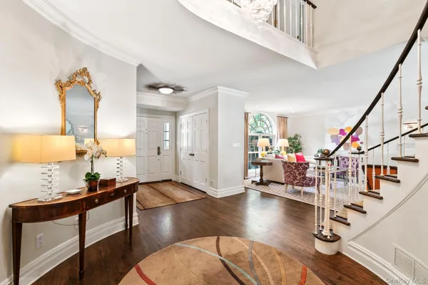 a living room with lots of furniture and a wooden floor