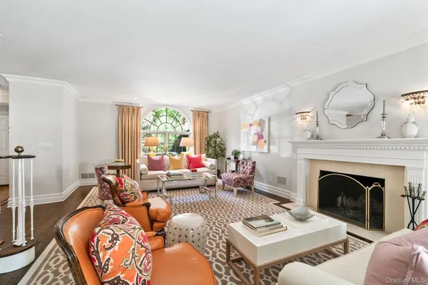 a living room with furniture a fireplace and a large window