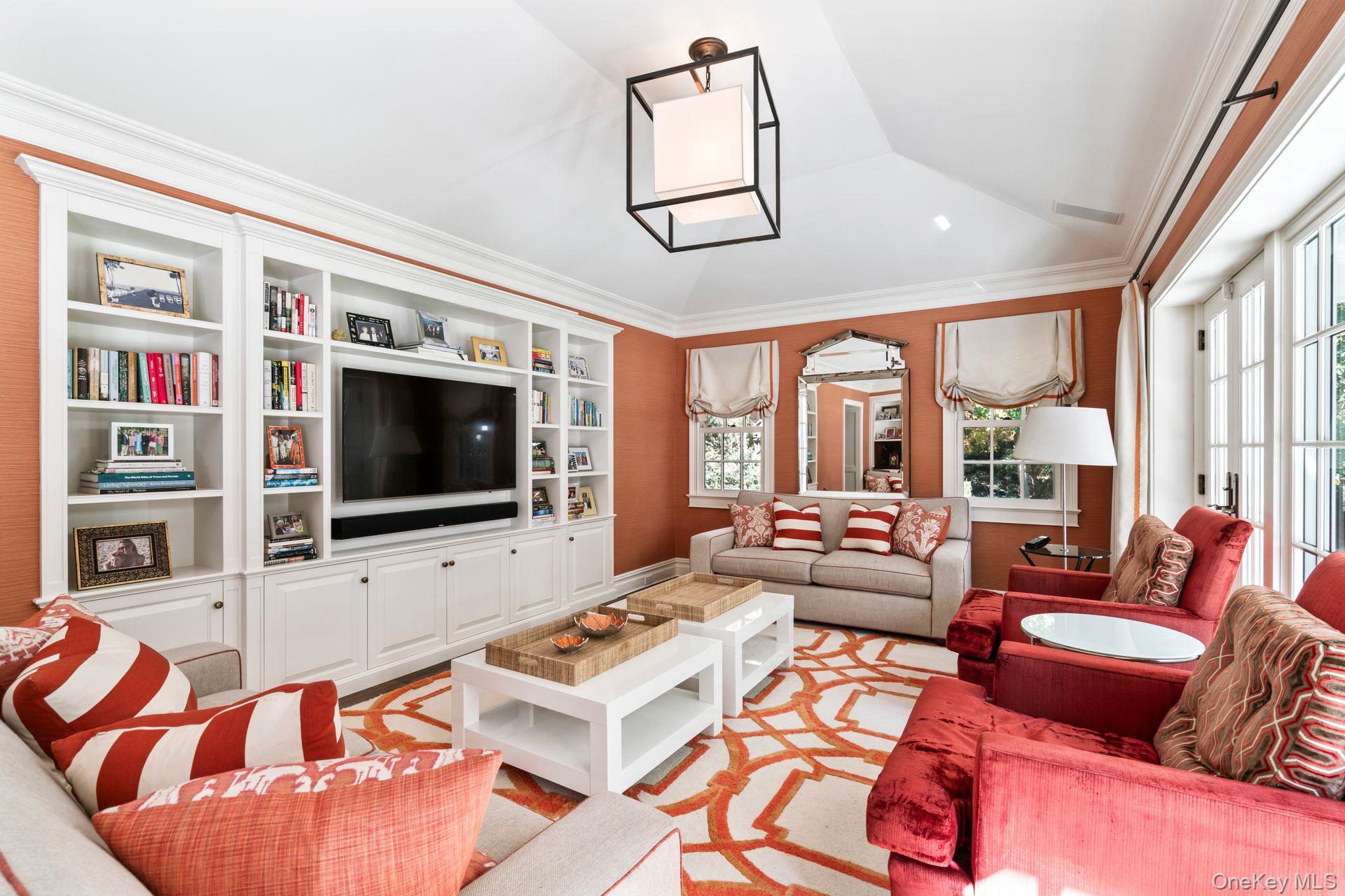 30 Underhill Road Locust Valley, NY 11560 - Photo 9 of 32 a living room with furniture a flat screen tv and a floor to ceiling window