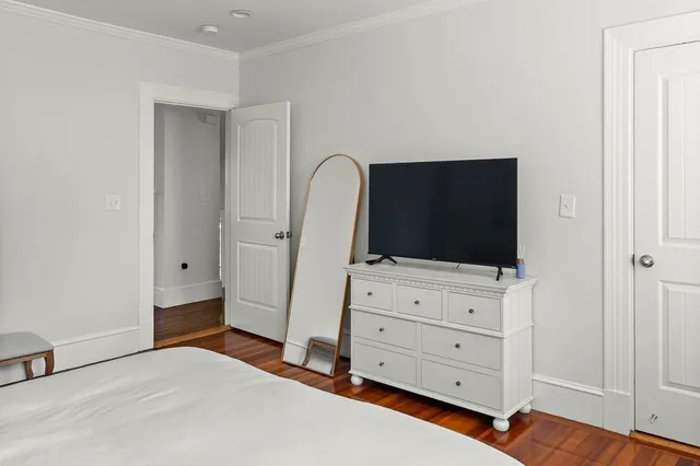a bedroom with a bed and flat screen tv