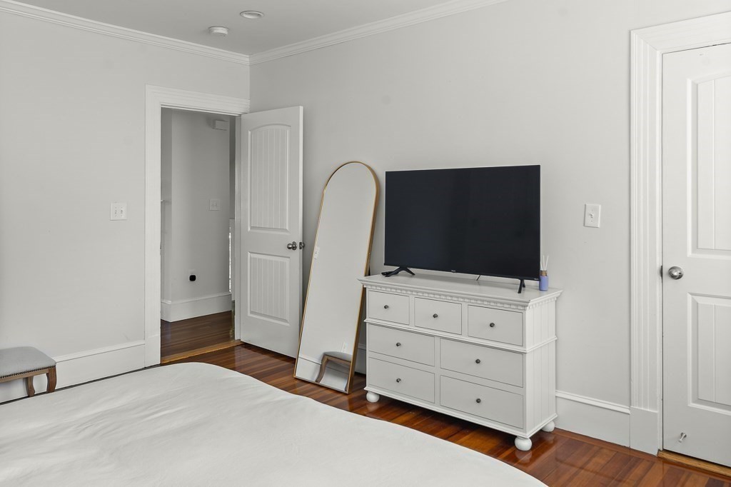1281 Walnut Street, Unit 2 Newton, MA 02461 - Photo 11 of 30 a bedroom with a bed and flat screen tv