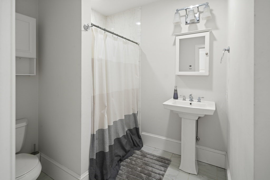 1281 Walnut Street, Unit 2 Newton, MA 02461 - Photo 12 of 30 a bathroom with a sink toilet and shower