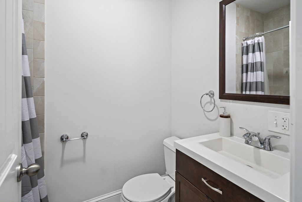 1281 Walnut Street, Unit 2 Newton, MA 02461 - Photo 13 of 30 a bathroom with a sink toilet and mirror