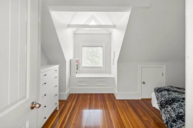a view of a livingroom with wooden floor and entryway