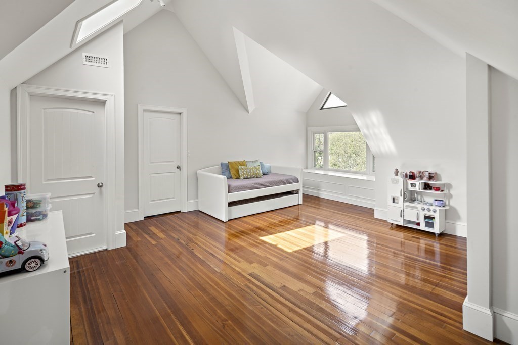 1281 Walnut Street, Unit 2 Newton, MA 02461 - Photo 22 of 30 a bedroom with furniture and a wooden floor
