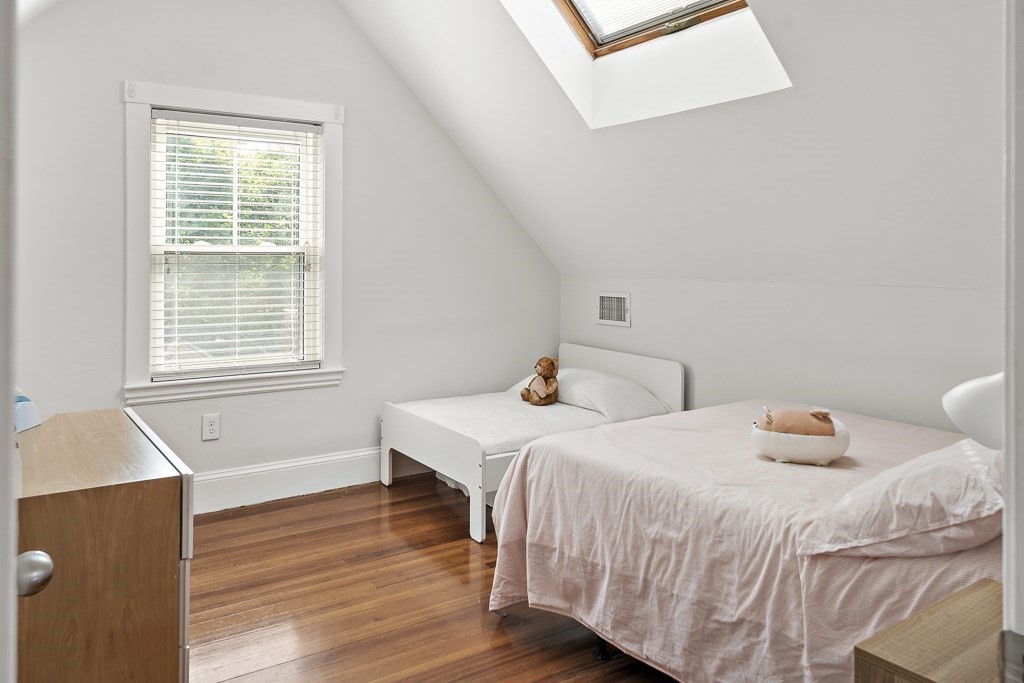 1281 Walnut Street, Unit 2 Newton, MA 02461 - Photo 25 of 30 a bedroom with two beds and wooden floor
