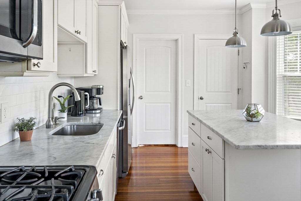 1281 Walnut Street, Unit 2 Newton, MA 02461 - Photo 7 of 30 a kitchen with granite countertop a sink stove and cabinets