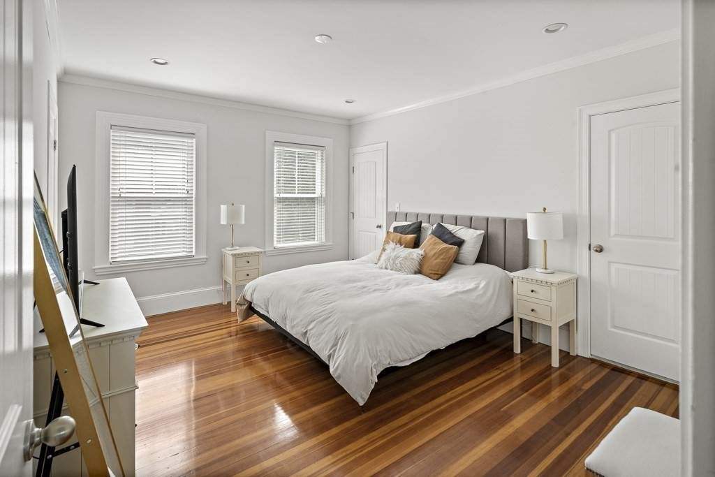 1281 Walnut Street, Unit 2 Newton, MA 02461 - Photo 9 of 30 a bedroom with a bed and wooden floor