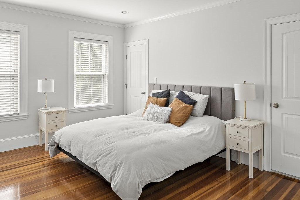 1281 Walnut Street, Unit 2 Newton, MA 02461 - Photo 10 of 30 a bedroom with a bed and wooden floor