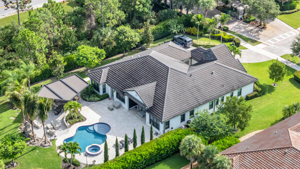 an aerial view of a house with a yard and potted plants