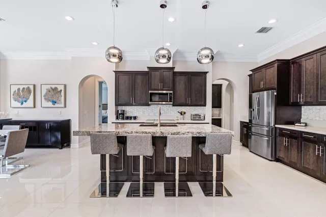 a large kitchen with a table and chairs