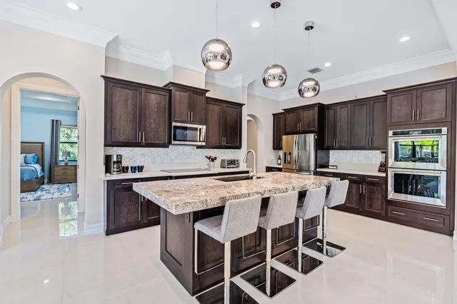 a large kitchen with a table and chairs