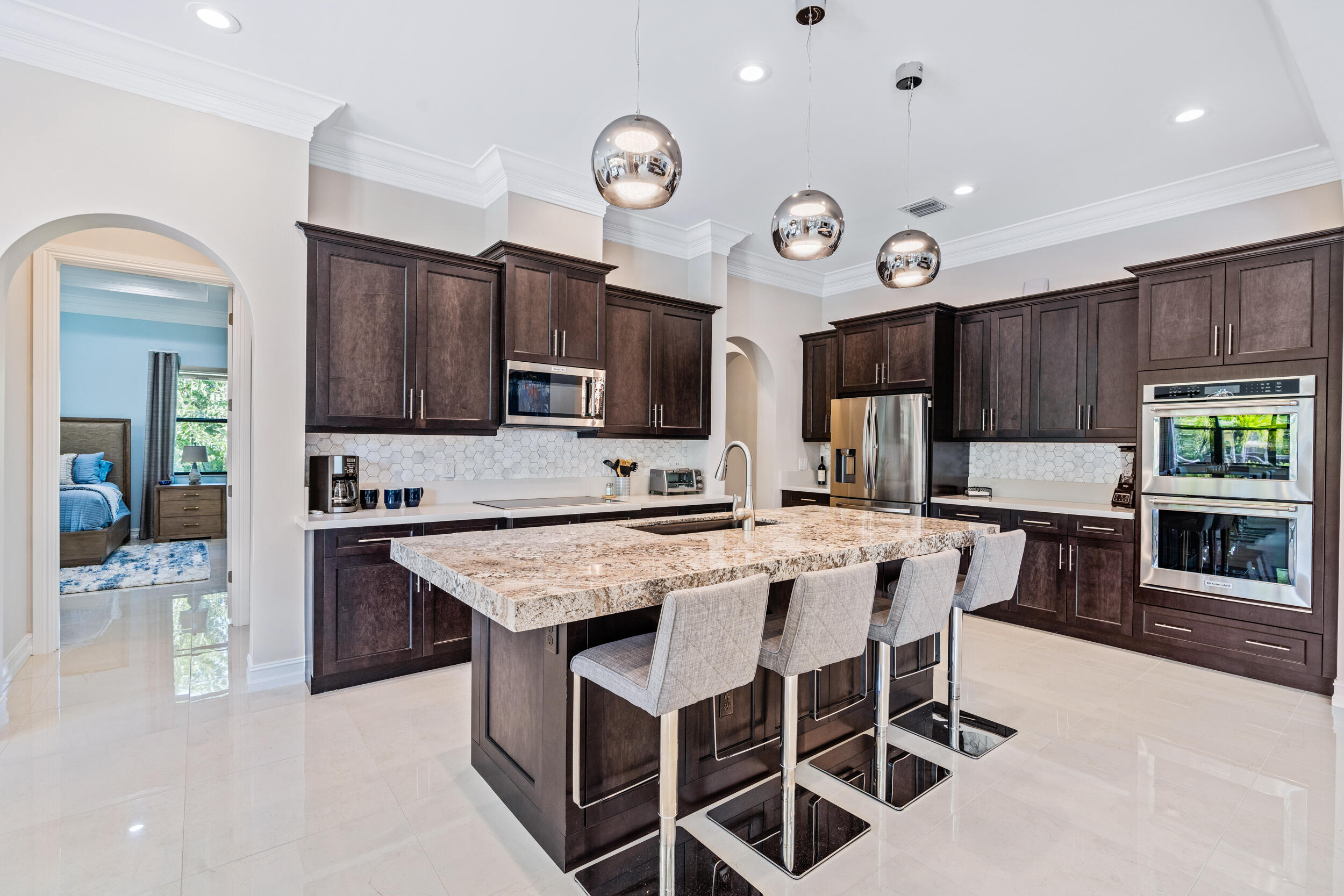 19240 Southeast Hidden Bridge Court Jupiter, FL 33458 - Photo 13 of 42 a large kitchen with a table and chairs