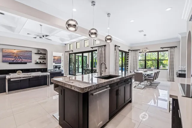 a large kitchen with granite countertop a sink and a stove