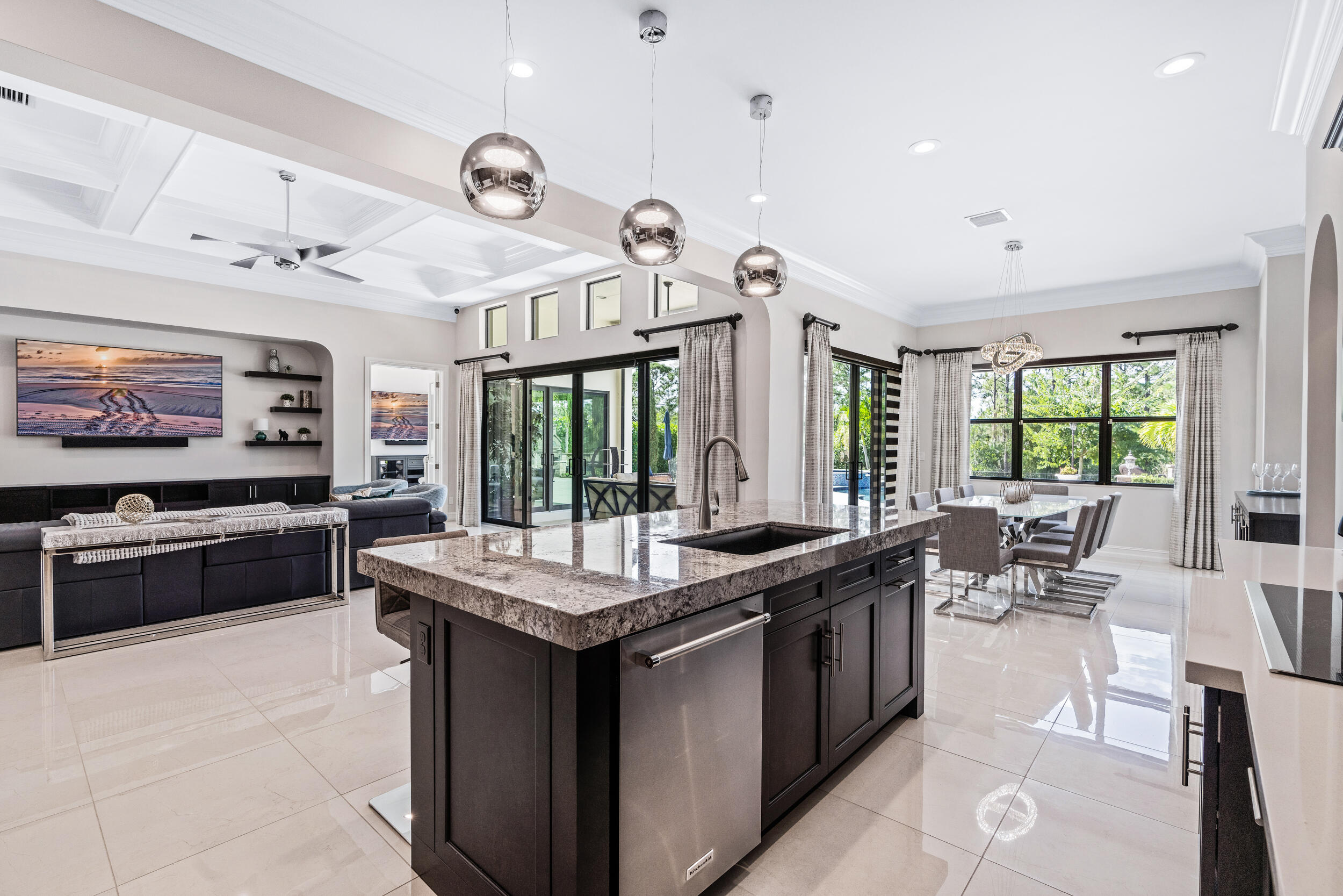 19240 Southeast Hidden Bridge Court Jupiter, FL 33458 - Photo 14 of 42 a large kitchen with granite countertop a sink and a stove