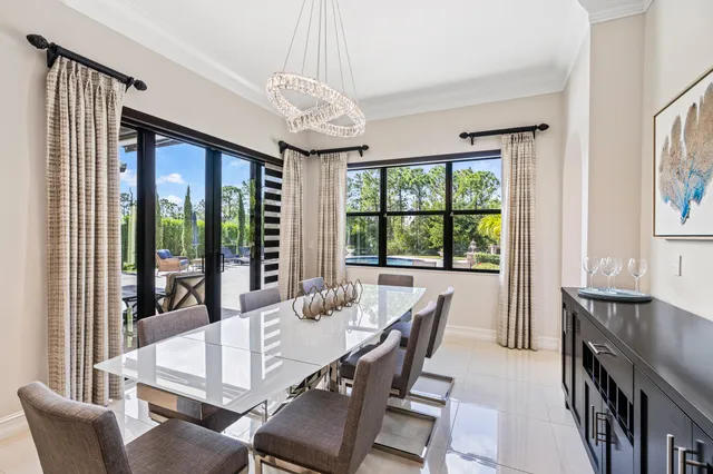 a view of a dining room with furniture large windows and wooden floor
