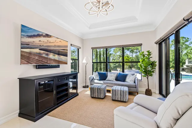 a living room with furniture a large window