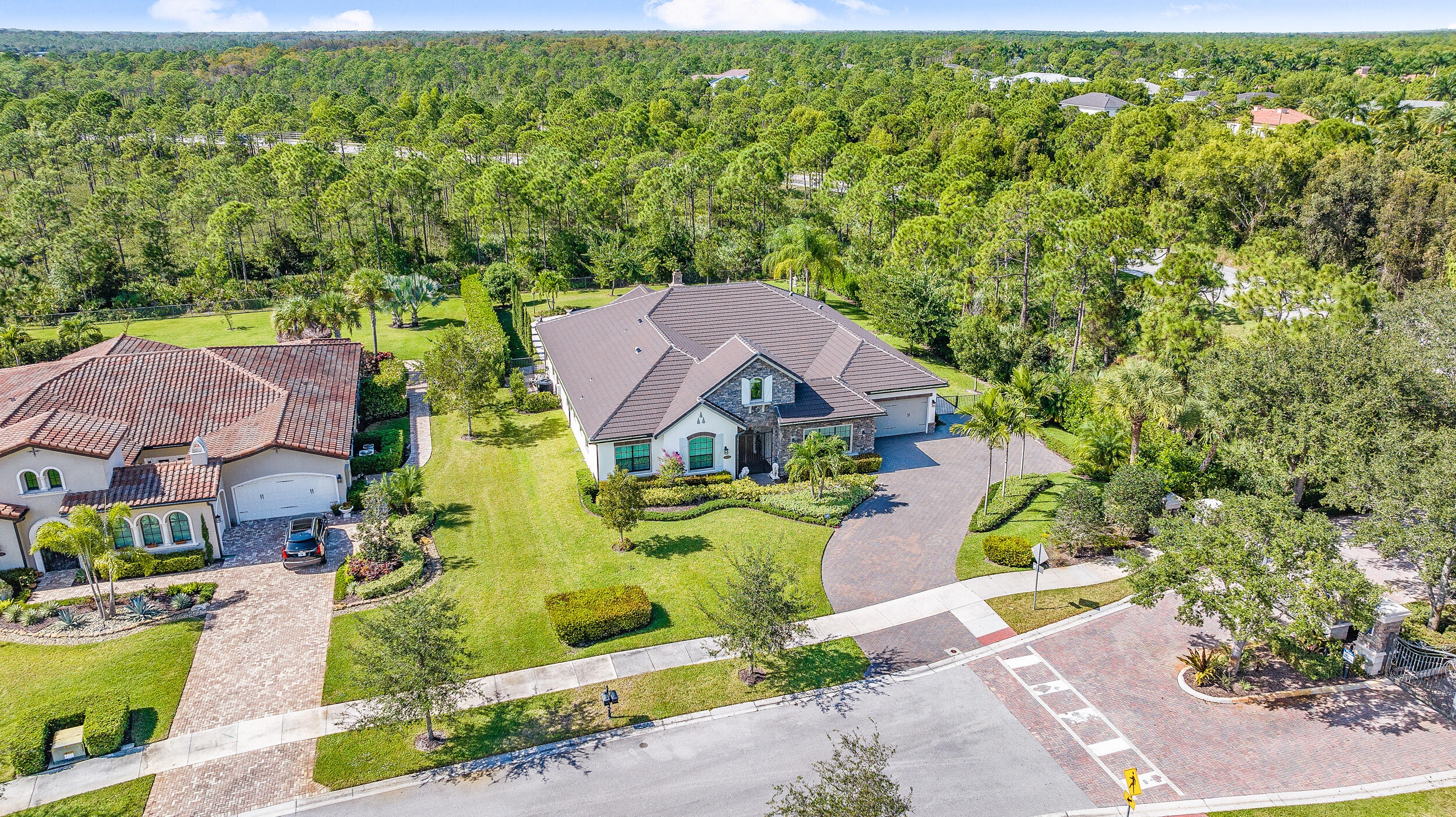 19240 Southeast Hidden Bridge Court Jupiter, FL 33458 - Photo 2 of 42 an aerial view of a house with a garden