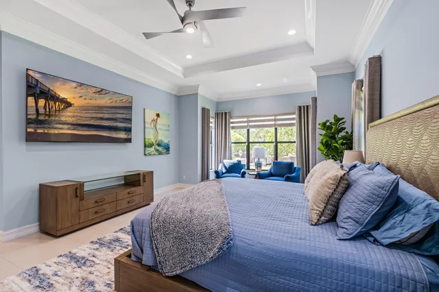 a spacious bedroom with a bed and glass windows