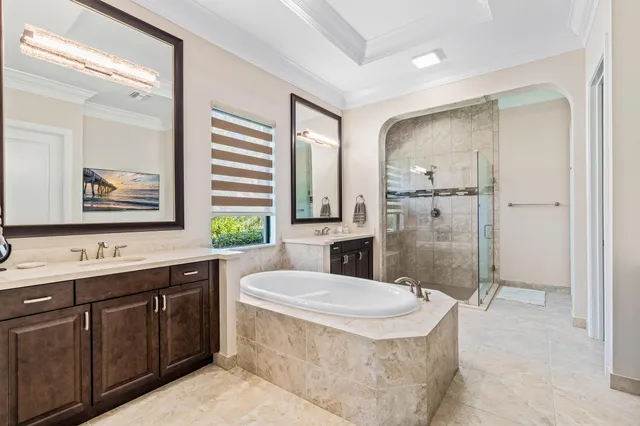 a bathroom with a granite countertop sink mirror bathtub and toilet