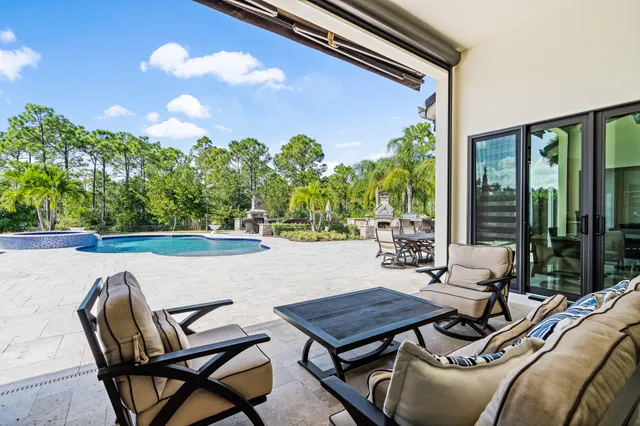 a view of a patio with table and chairs and potted plants