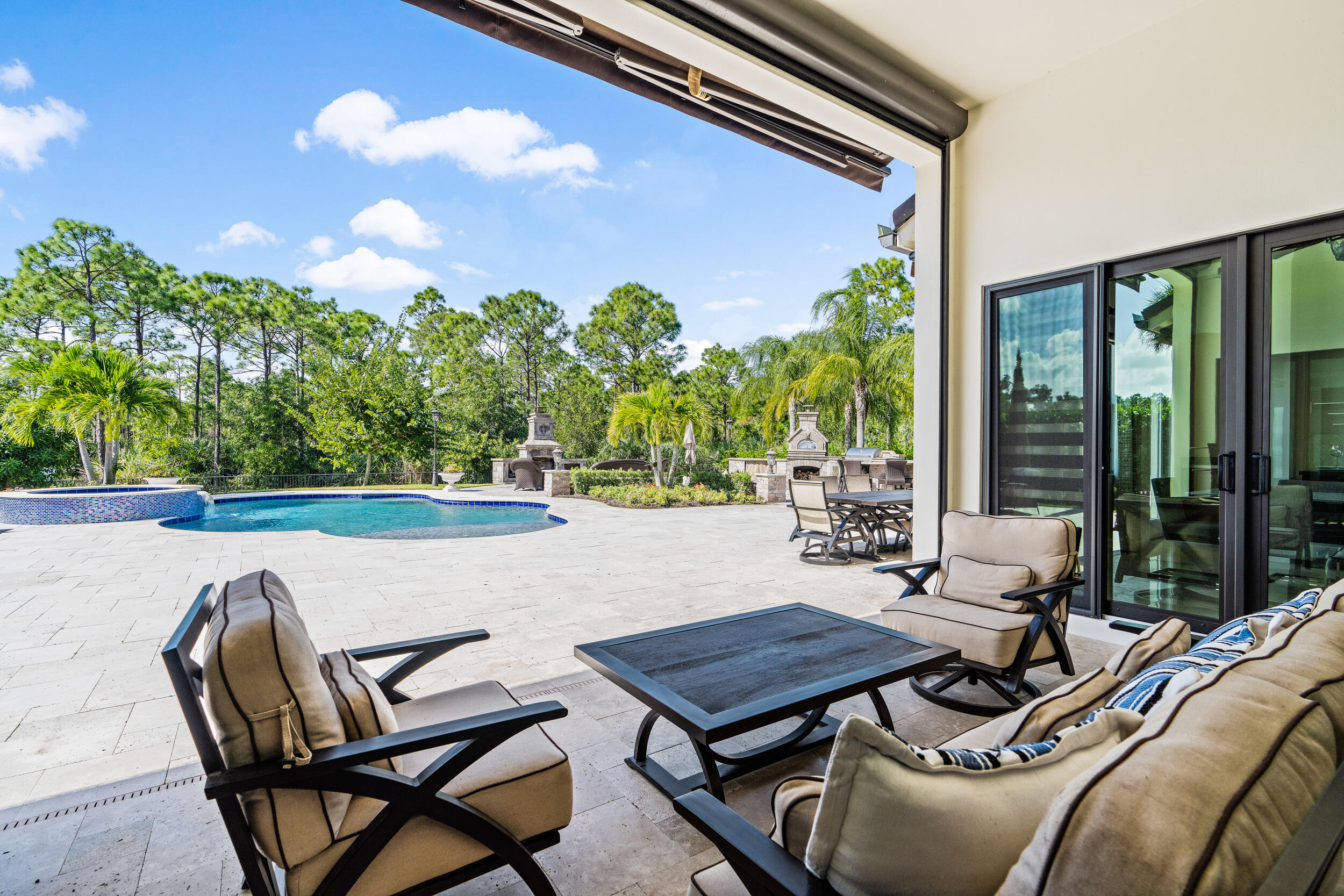 19240 Southeast Hidden Bridge Court Jupiter, FL 33458 - Photo 33 of 42 a view of a patio with table and chairs and potted plants