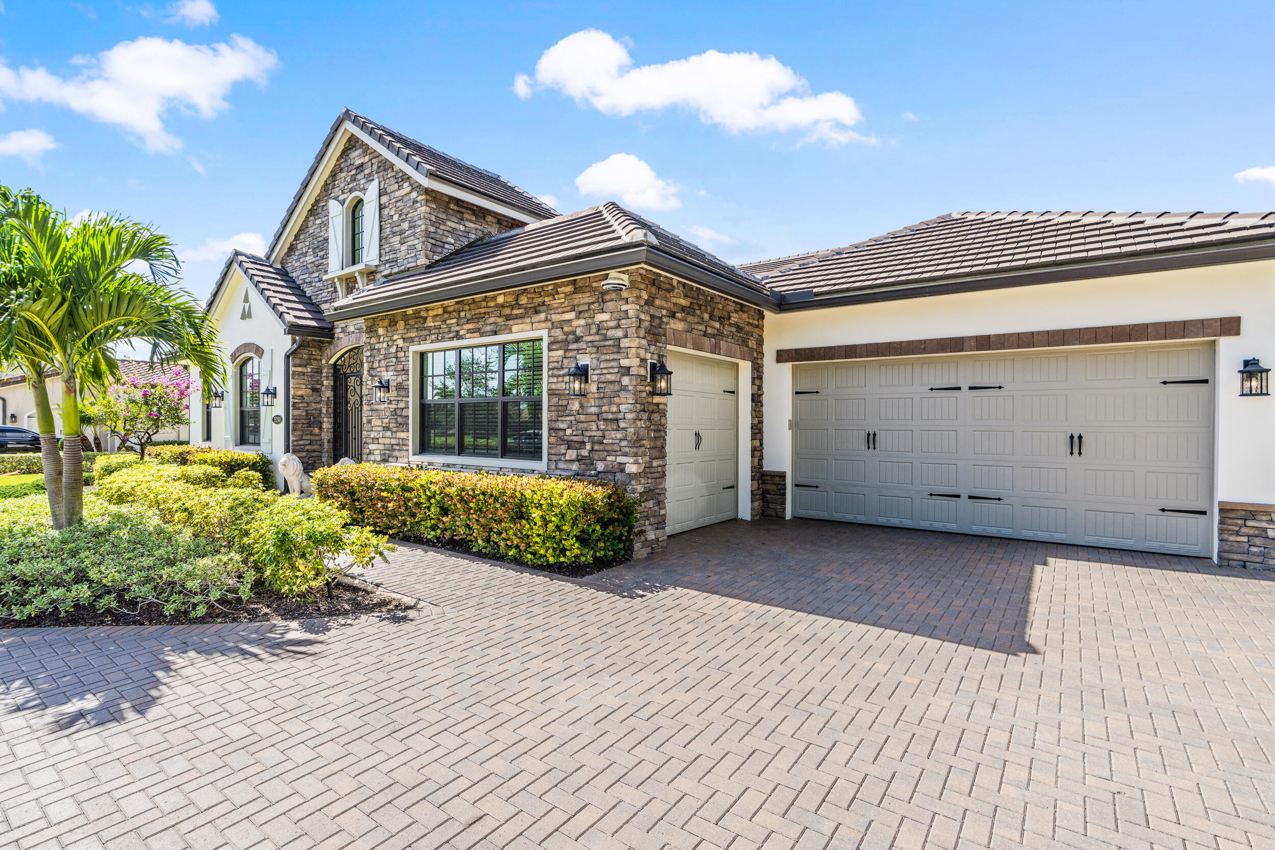 19240 Southeast Hidden Bridge Court Jupiter, FL 33458 - Photo 5 of 42 a view of a house with a wooden fence