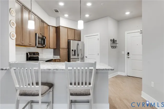 a large kitchen with a table and chairs