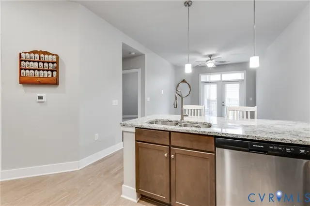 a kitchen with stainless steel appliances kitchen island granite countertop a refrigerator and a stove top oven