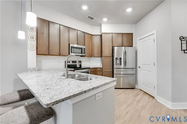 a kitchen with a refrigerator sink and microwave