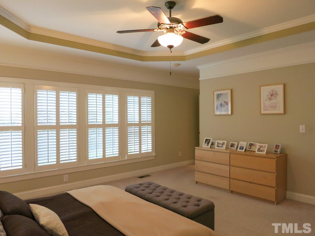 3205 Canes Way Raleigh, NC 27614 - Photo 11 of 25 Spacious 1st floor Master Bedroom features a tray ceiling, neutral carpet, lots of windows & huge WIC.