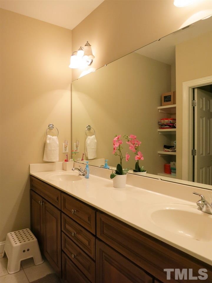 3205 Canes Way Raleigh, NC 27614 - Photo 19 of 25 The Bedrooms share the tiled Hall Bath w/double sinks, linen shelving & separate tub/shower & toilet.