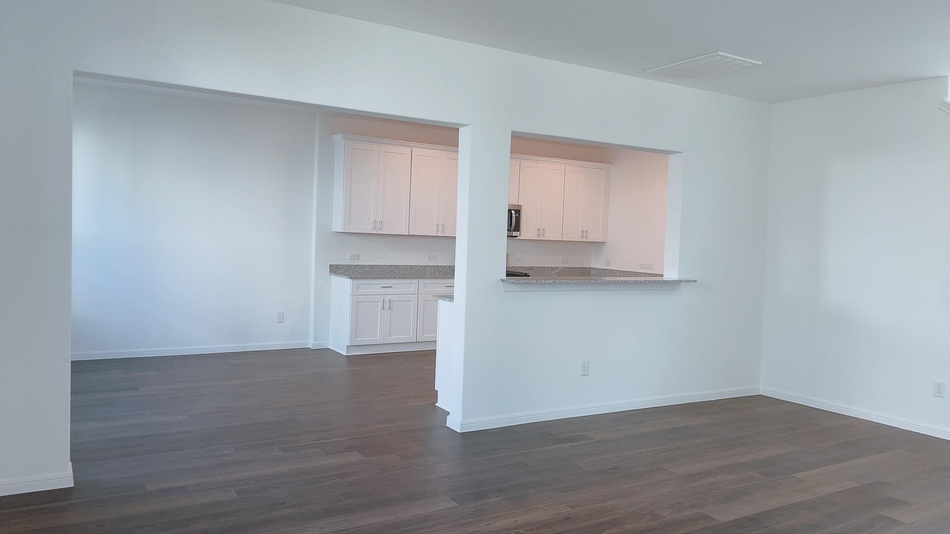 10212 Gates Mill Road Houston, TX 77034 - Photo 6 of 17 a view of a kitchen with wooden floor and cabinets