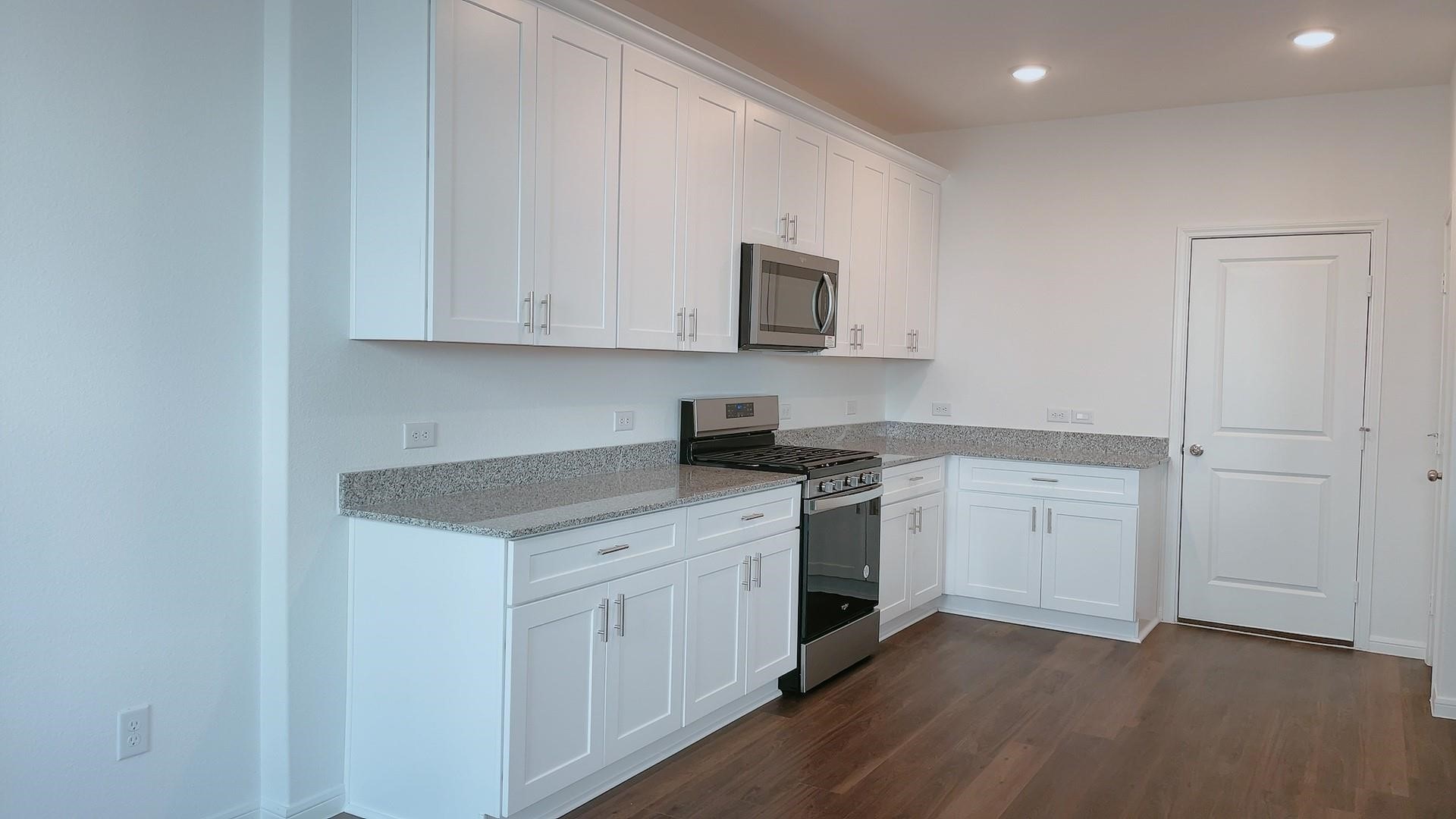 10212 Gates Mill Road Houston, TX 77034 - Photo 8 of 17 a kitchen with stainless steel appliances granite countertop a stove a sink and a microwave