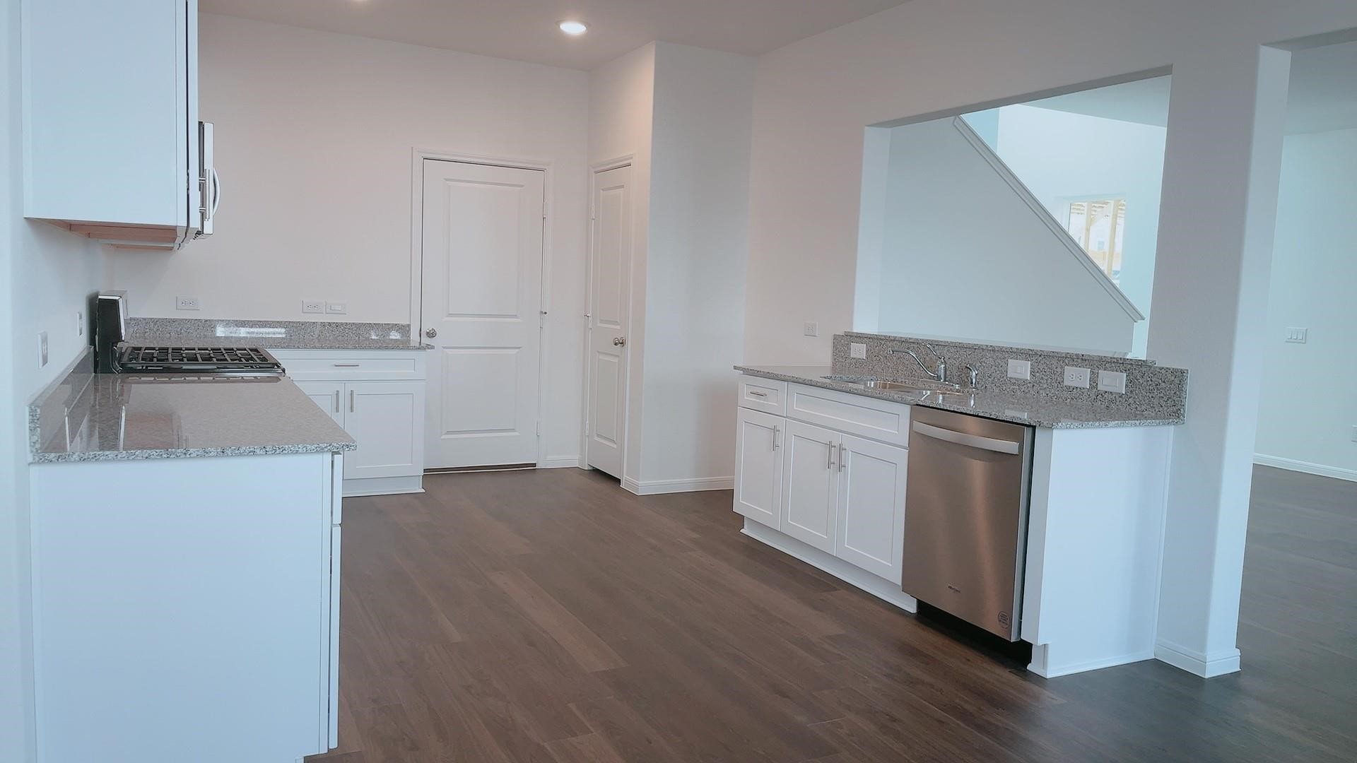 10212 Gates Mill Road Houston, TX 77034 - Photo 9 of 17 a kitchen with a sink stove and cabinets