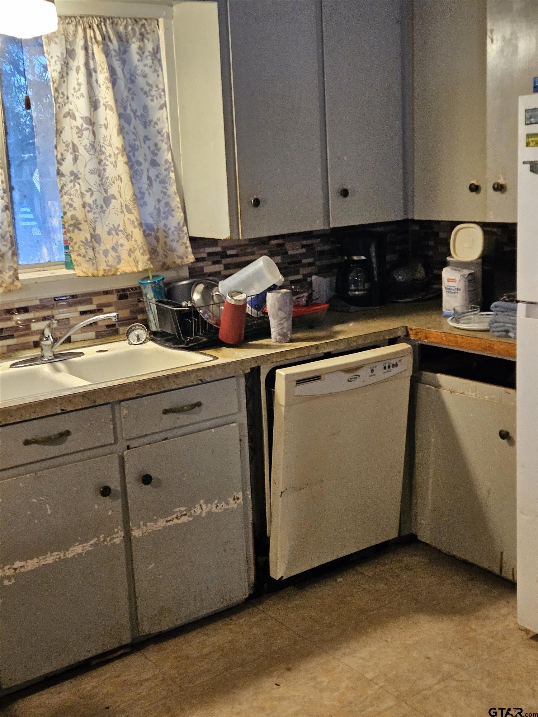 5542 Farm To Market Road 752 Rusk, TX 75785 - Photo 5 of 41 a kitchen with granite countertop cabinets sink and white appliances