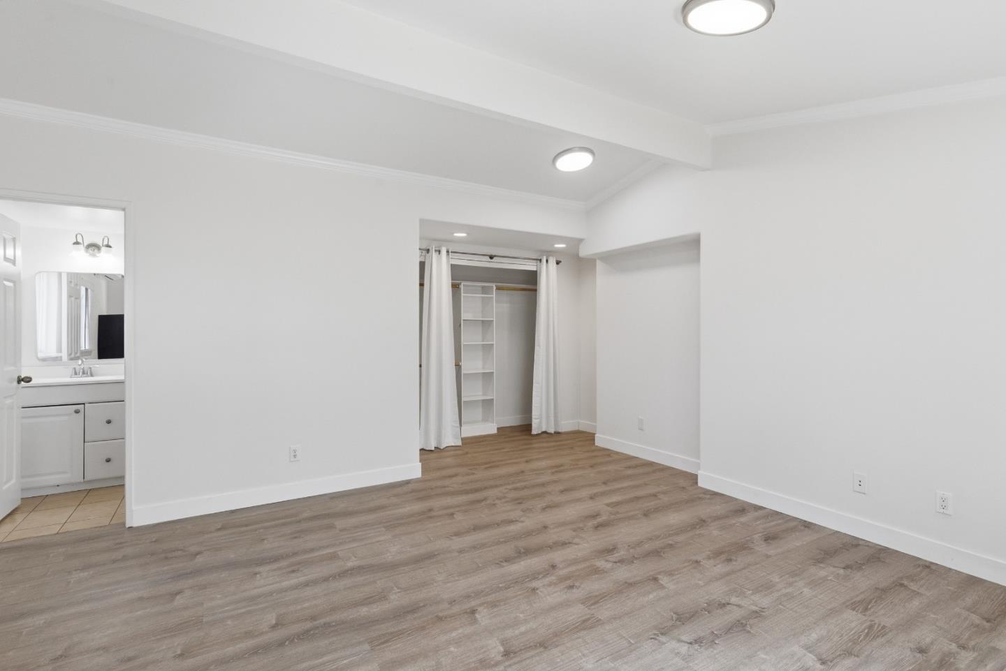 8894 Indiana Avenue Riverside, CA 92503 - Photo 11 of 16 a view of a room with wooden floor and white walls