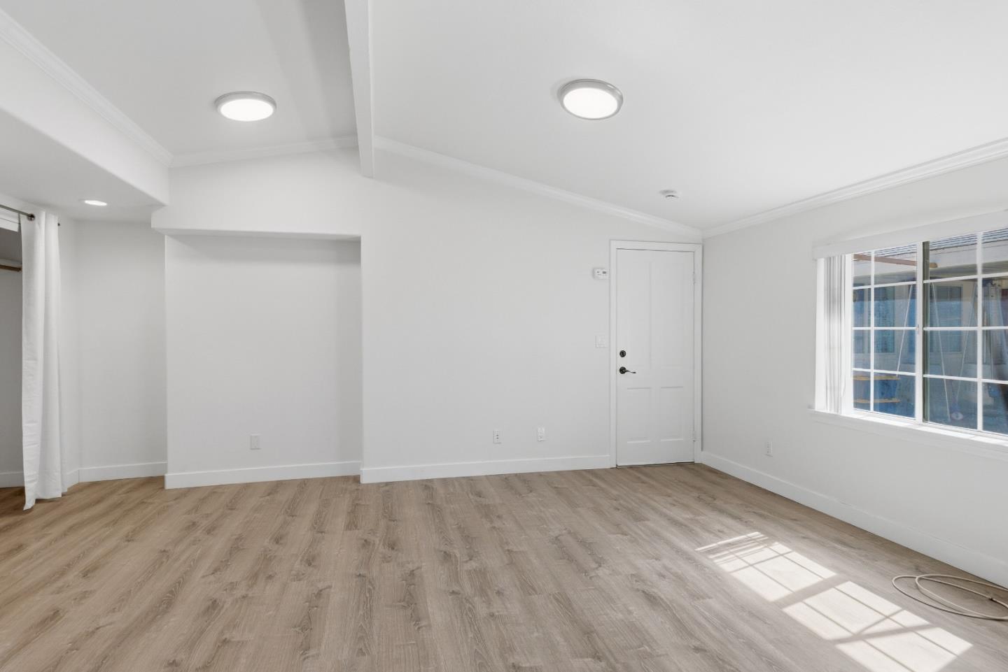 8894 Indiana Avenue Riverside, CA 92503 - Photo 12 of 16 wooden floor in an empty room with a window